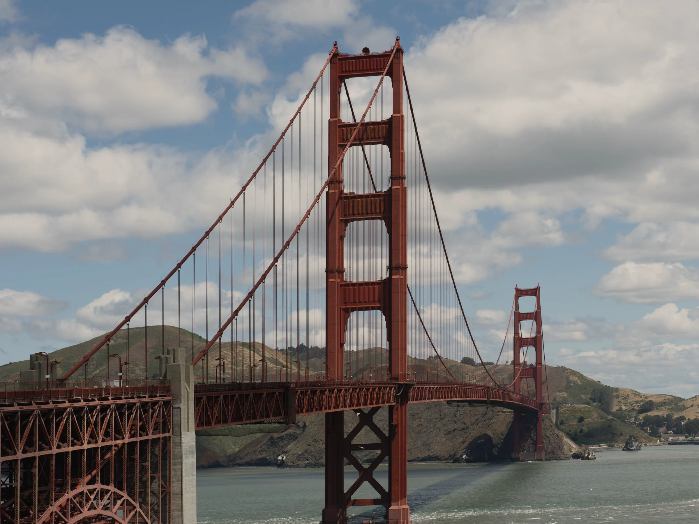 The Golden Gate Bridge from the Marin shore, its towers red over the bay and the headlands beyond