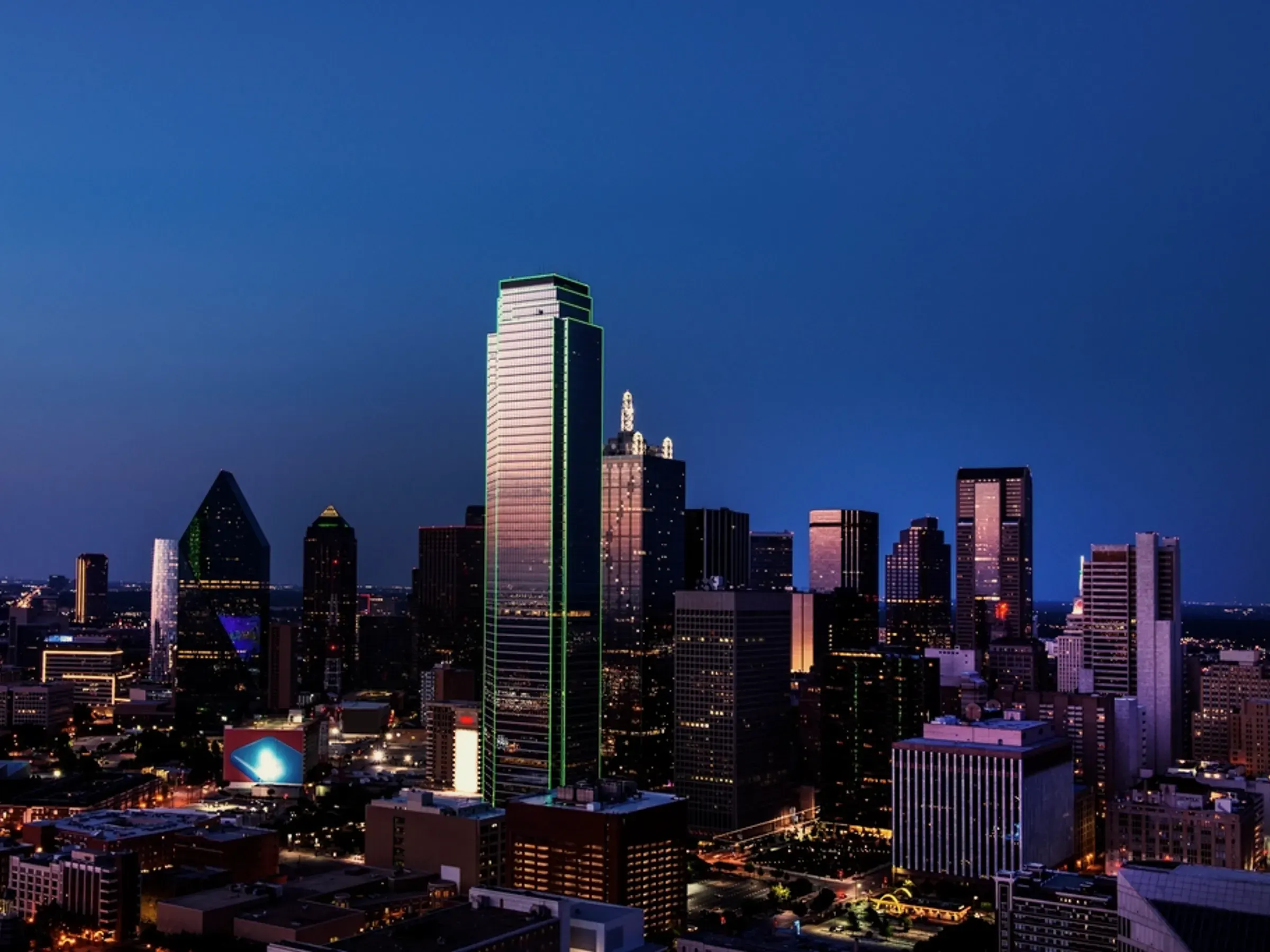 The Dallas skyline after dark, Reunion Tower and the green-lit Bank of America Plaza