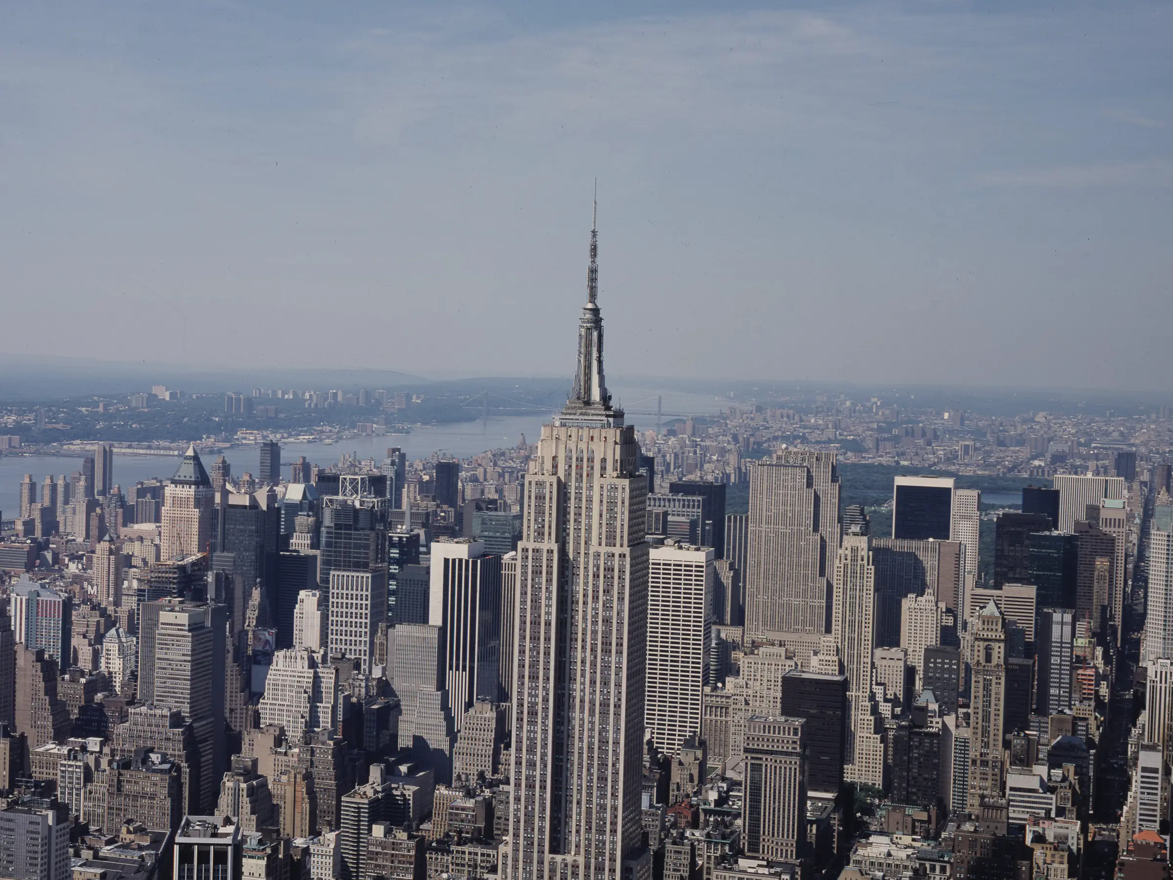 The Empire State Building rising out of midtown Manhattan, the city packed to the rivers on both sides